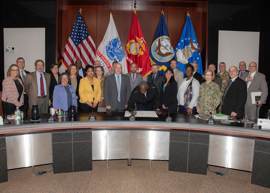 Members of the DLA Executive Board watch as DLA Director Army Lt. Gen. Darrell Williams signs the signs the 2019 Sexual Assault Awareness and Prevention Month Proclamation.