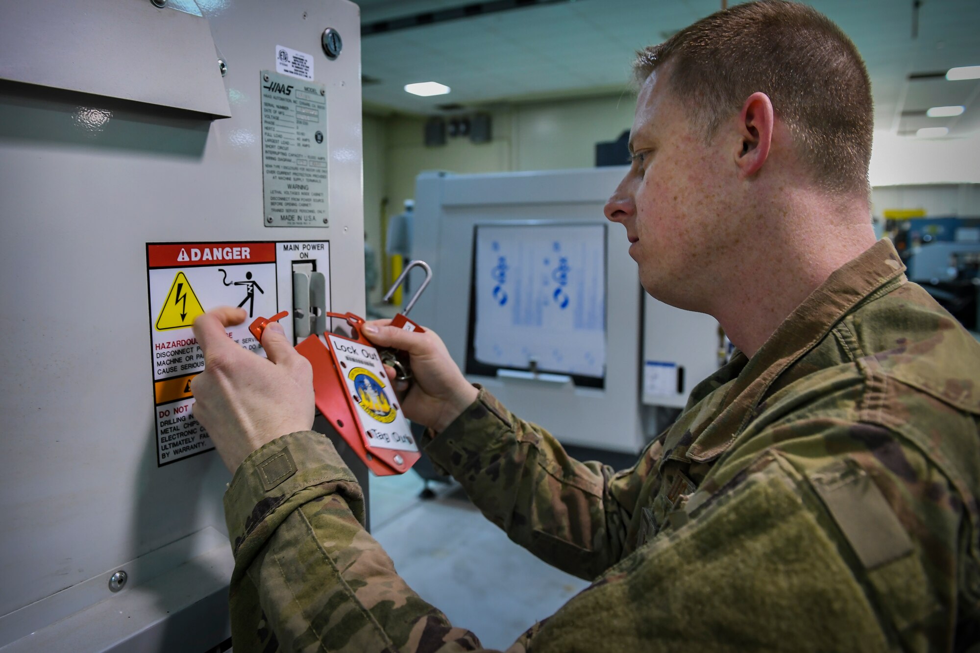 Tech. Sgt. Michael Howard, safety representative with the 911th Maintenance Squadron Metals Technology Shop, locks a piece of equipment at its power source while learning the machine’s safety procedures at March Air Reserve Base, California, March 5, 2019. The machine is similar to the equipment the 911th MXS will be receiving at their home station and learning the safety precautions is a priority requirement for working with them. (U.S. Air Force photo by Joshua J. Seybert)