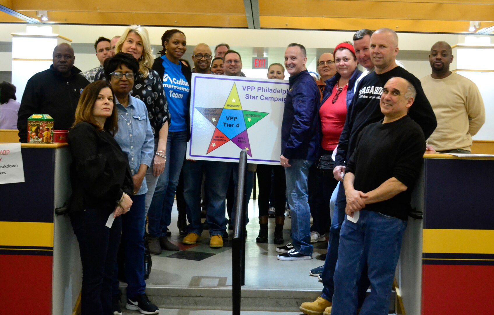 DLA Troop Support Construction and Equipment supply chain employees pose for a photo during the spring clean-up event in Building 3 March 20, 2019 in Philadelphia. The employees participated in the housekeeping component of the VPP program, an OSHA led initiative, that encourages cooperative efforts between management, employees and unions to reduce mishaps, pest and improve workplace safety. (Photo by Alexandria Brimage-Gray).