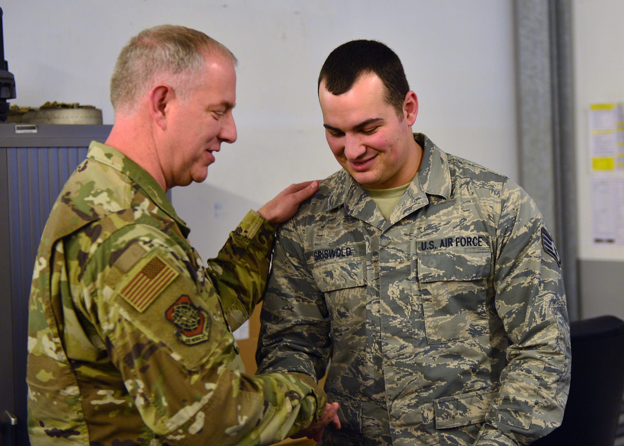 U.S. Air Force Maj. Gen. John Gordy, U.S. Air Force Expeditionary Center commander, hands a coin to Staff Sgt. Cody Griswold, 721 Aircraft Maintenance Squadron vehicle noncommissioned officer, for outstanding performance in his unit at Ramstein Air Base, Germany, March 14, 2019.