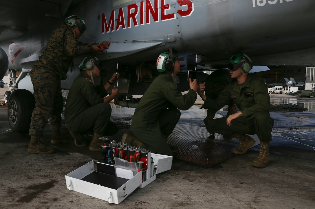 Marines with Marine Fighter Attack Squadron (VMFA) 232, Marine Aircraft Group (MAG) 11, 3rd Marine Aircraft Wing (MAW), tighten a base plate to the undercarriage of an aircraft prior to takeoff at Marine Corps Air Station (MCAS) Miramar, Calif., March 8. The Red Devils are in the Unit Deployment Program rotation and are preparing to depart for MCAS Iwakuni, Japan. Their mission during the six-month deployment is to strengthen relationships, modernize U.S. alliances and support joint security in the Indo-Pacific region. (U.S. Marine Corps photo by Lance Cpl. Levi J. Guerra)