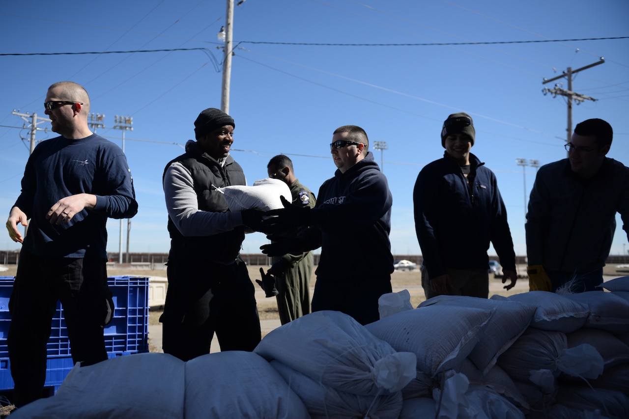 Airmen fill sandbags.