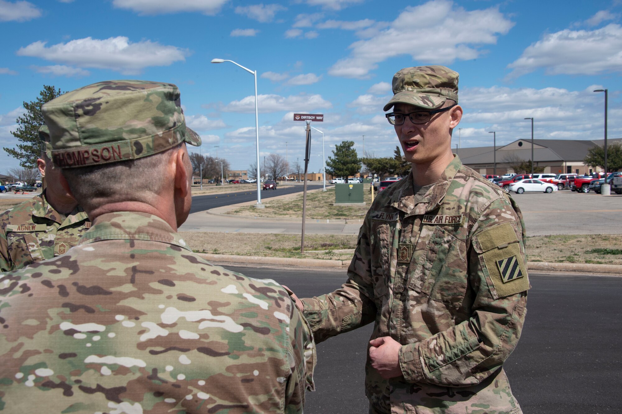 U.S. Air Force Senior Master Sgt. Thomas Flynn, 97th Civil Engineer Squadron heavy repair superintendent, explains the road construction training taught to Airmen of the 97th CES to Chief Master Sgt. Erik Thompson, command chief of the 19th Air Force,