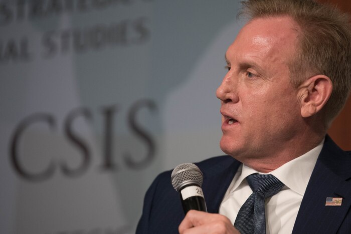 A man speaks into a microphone.