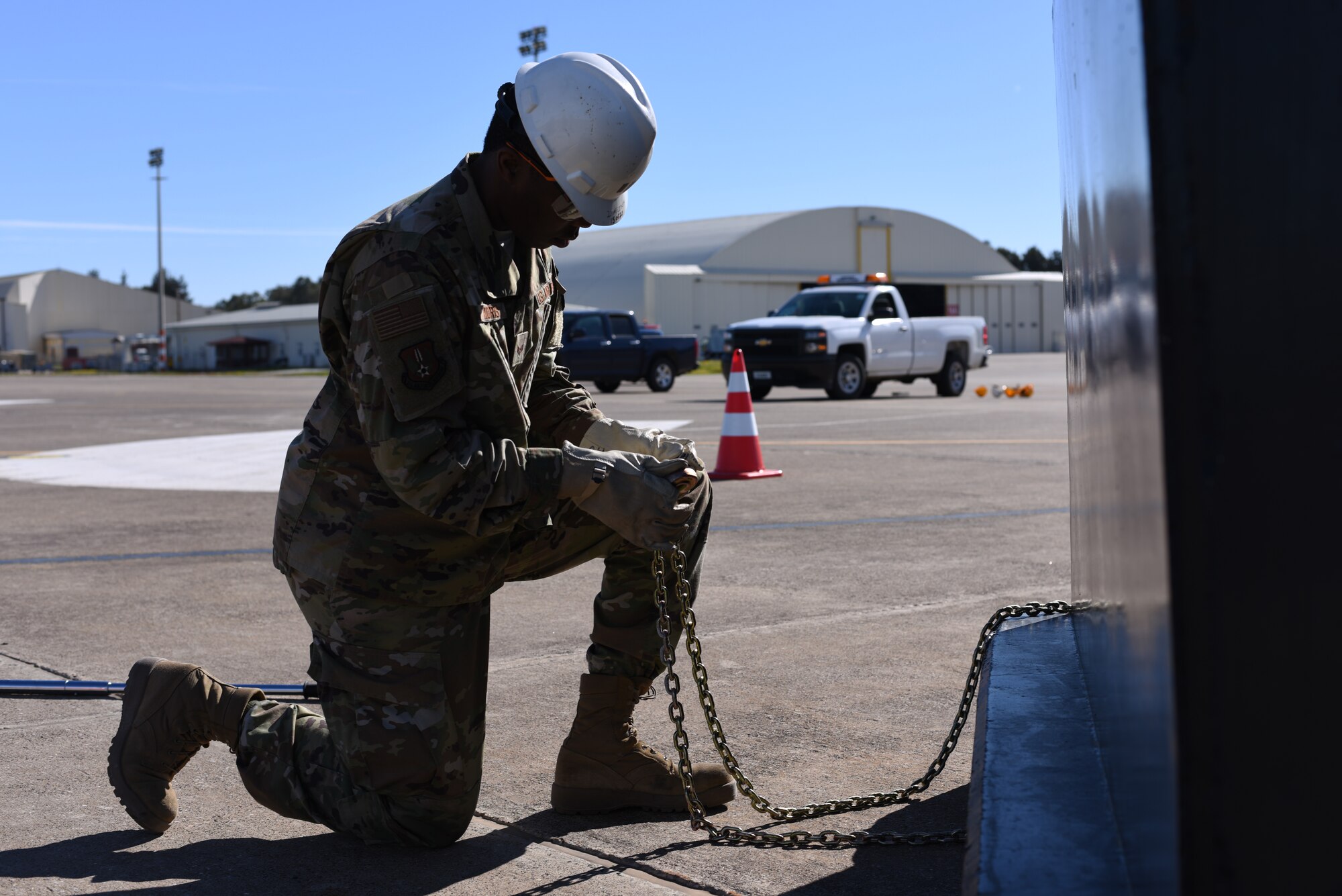 Airman 1st Class Jamere Morris, 39thMaintenance Squadron crew chief, ties a chain to a jersey barrier to stabilize cables attached to an F-4 Phantom II March 8, 2019, at Incirlik Air Base, Turkey.