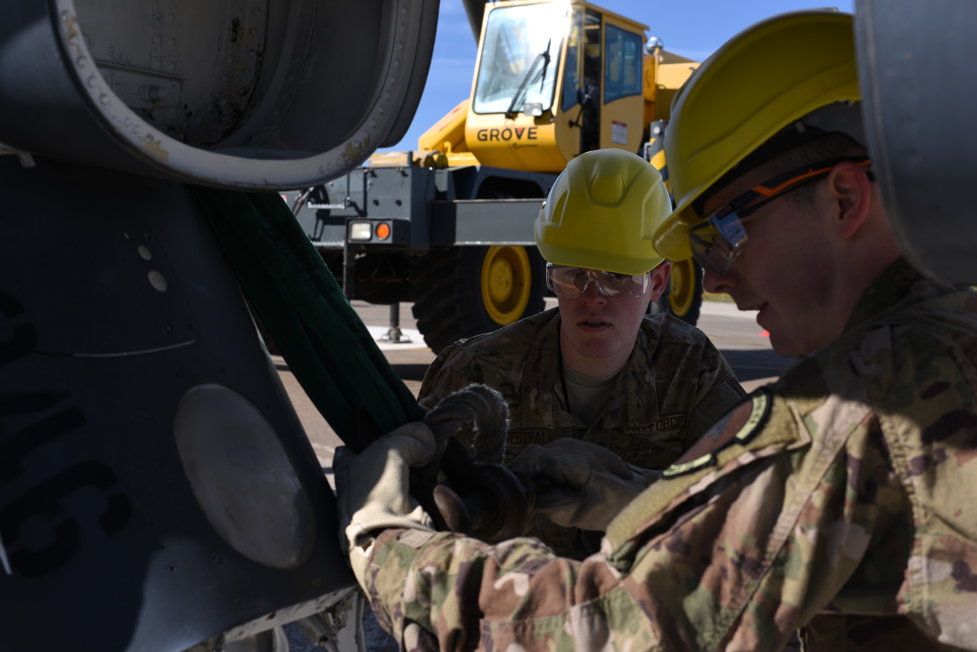 Senior Airman Austin Westfall, 39th Maintenance Squadron crew chief, watches Staff Sgt. Cody Walker, 39th MXS crew chief, tie a sling around an F-4 Phantom II at March 8, 2019, at Incirlik Air Base, Turkey.