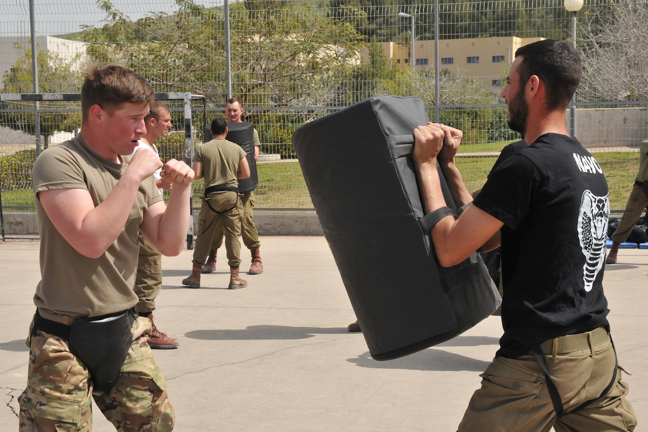 Israeli and U.S. troops practice hand-to-hand combat.
