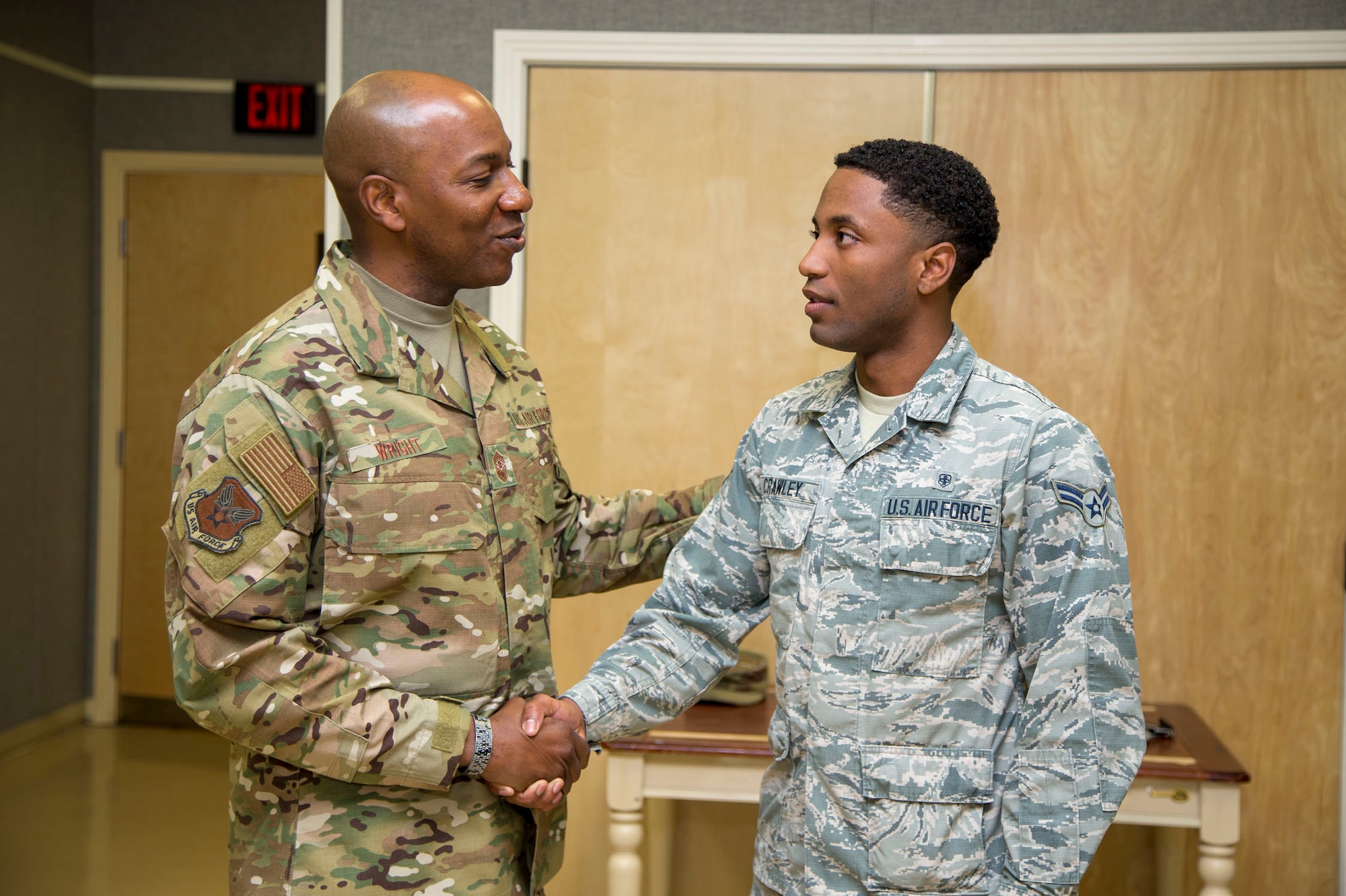 Chief Master Sgt. of the Air Force Kaleth O. Wright (left) presents a challenge coin for a job well done to Airman 1st Class Thierry Crawley, 412th Medical Group, Mental Health technician, March 19, 2019. (U.S. Air Force photo by Christopher Okula)