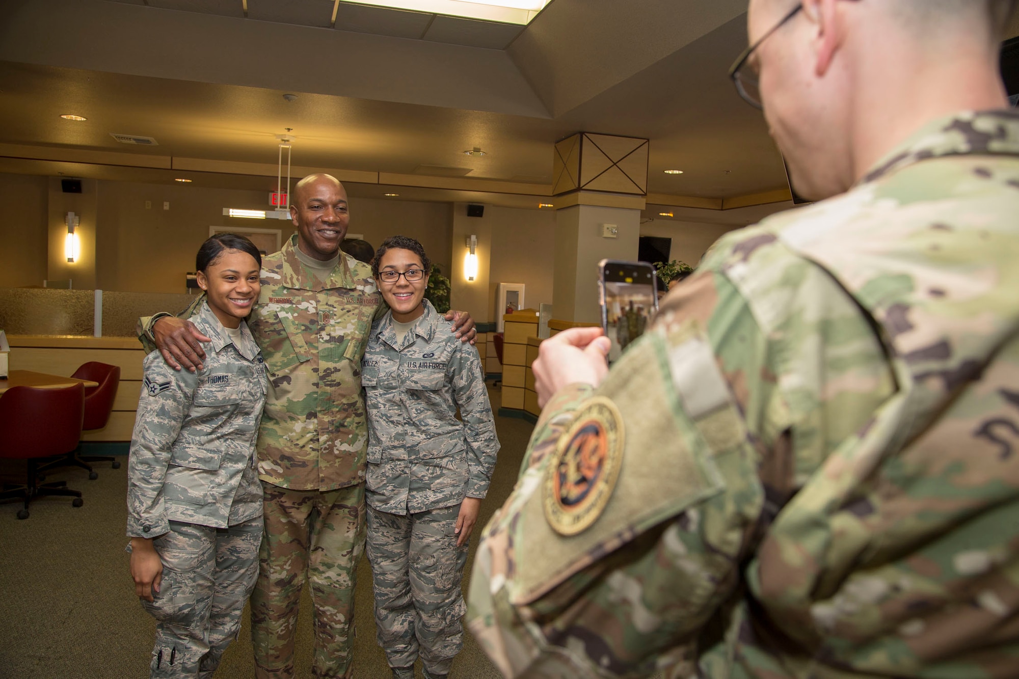 Chief Master Sgt. of the Air Force Kaleth O. Wright poses for a photo with Airman 1st Class Kyesha Thomas, 412th Security Forces Squadron (left), and Airman 1st Class Parris Gonzalez, U.S. Air Force Test Pilot School, at the Joshua Tree Inn Dining Facility, March 18, 2019. The Air Force’s top enlisted Airman received a two-day tour of Edwards Air Force Base. (U.S. Air Force photo by Christopher Okula)