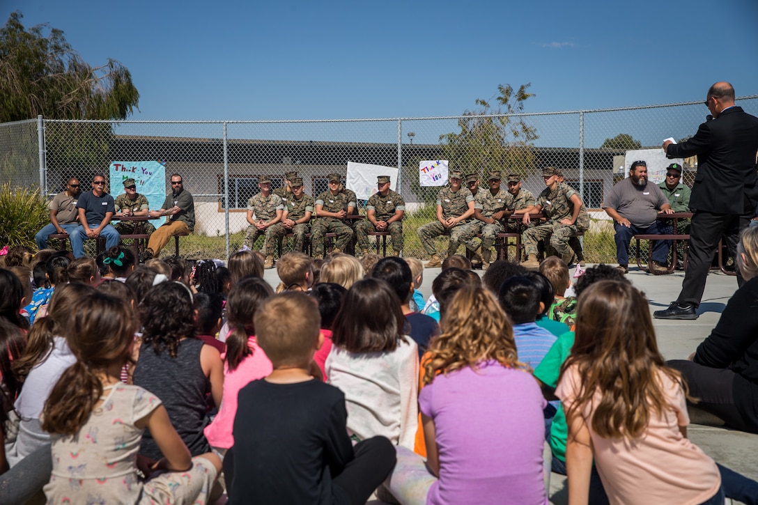 Frank English (far right), principal, Santa Margarita Elementary School, recognizes U.S. Marines with Bridge Company, 7th Engineer Support Battalion, 1st Marine Logistics Group, and contractors with Facilities Maintenance Department, Marine Corps Installations West, Marine Corps Base (MCB) Camp Pendleton,  during a “thank you” ceremony at Santa Margarita Elementary School on MCB Camp Pendleton, California, March 18, 2019. The students of the elementary school wrote personal “thank you” letters to the Marines and contractors for building a bridge over and repairing a sinkhole in Carnes Road that resulted in the evacuation and temporary closing of the school on Feb. 4. The sinkhole was caused by erosion resulting from persistent heavy rain storms that swept through Southern California. (U.S. Marine Corps photo by Cpl. Gabino Perez)