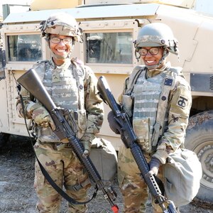 Two female Soldiers teaming up at JRTC