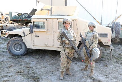 Two female Soldiers teaming up at JRTC