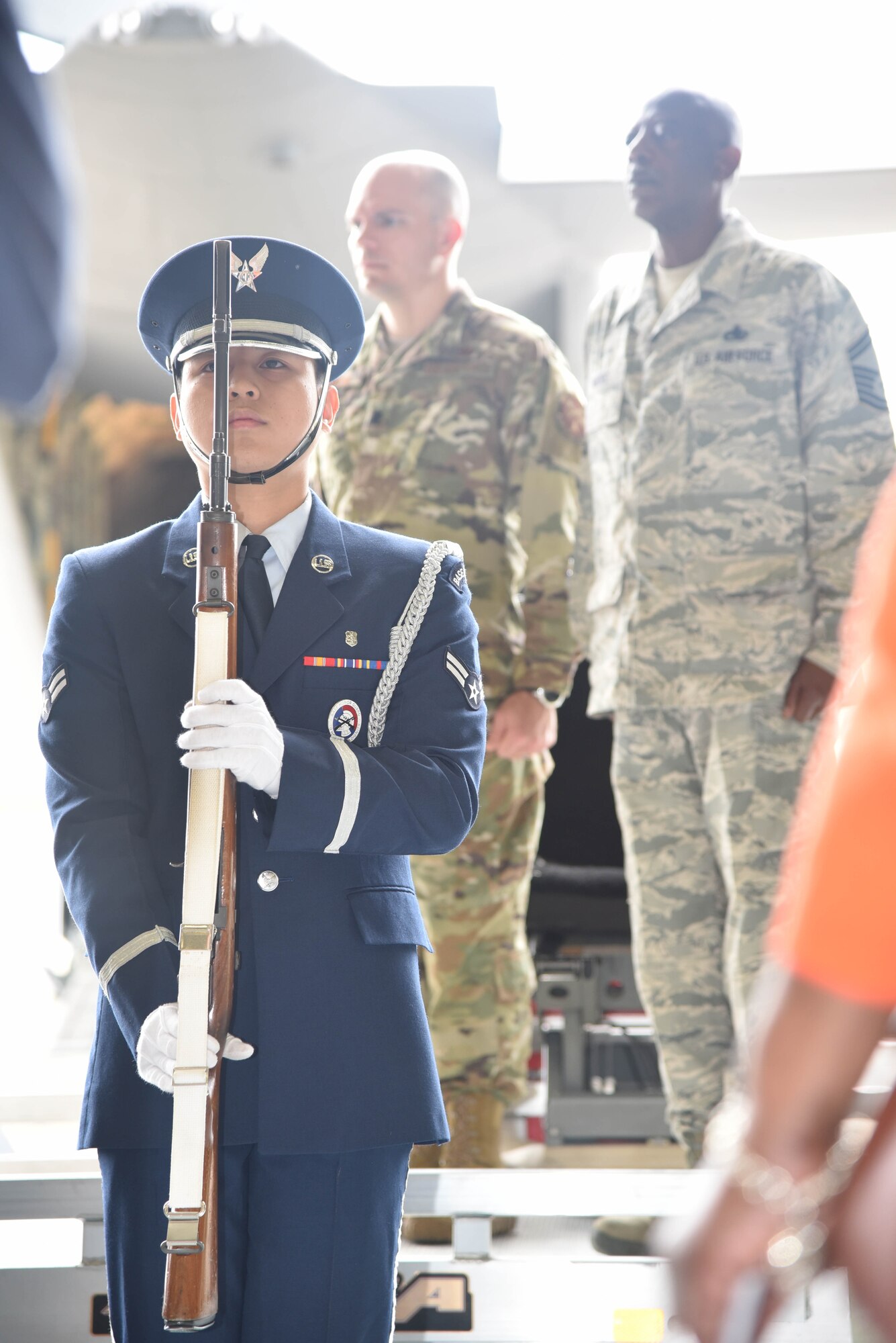 A member of the Keesler Air Force Base, Mississippi, Honor Guard stands at attention during the National Anthem as part of a retirement ceremony honoring Senior Master Sgt. Charles Moore March 8, 2019.  Moore retires from his duties as a production superintendent with the 803rd Aircraft  Maintenance Squadron April 1, 2019. He served 33-years in the Air Force Reserve. (U.S. Air Force photo by Tech. Sgt. Michael Farrar)