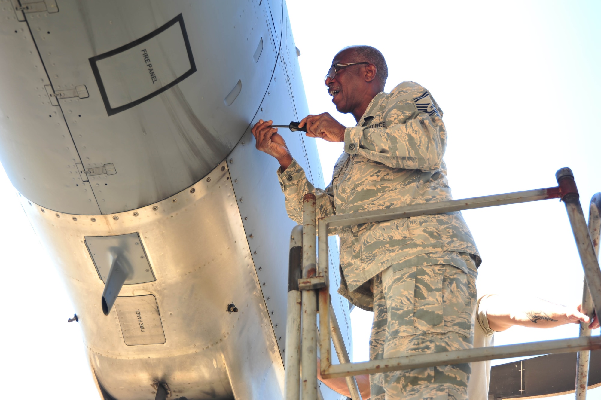 Senior Master Sgt. Charles Moore, 803rd Aircraft Maintenance Squadron production superintendent, unscrews C-130 Super Hercules engine cover on the Keesler Air Force Base, Mississippi, flight line. March 21, 2019.  Moore retires from a 33 year military career in the Air Force Reserve, April 1, 2019.(U.S. Air Force photo by Tech. Sgt. Michael Farrar)