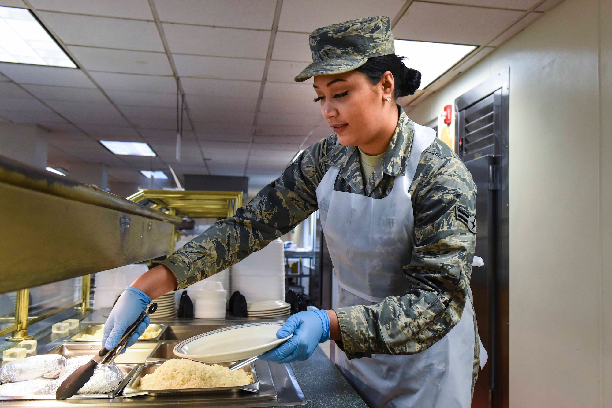 Airman 1st Class Chandramis Fue-Asuega, a food services specialist with the 419th Sustainment Services Flight, serves lunch March 2, 2019, at the Hillcrest Dinning Facility on Hill Air Force Base, Utah.