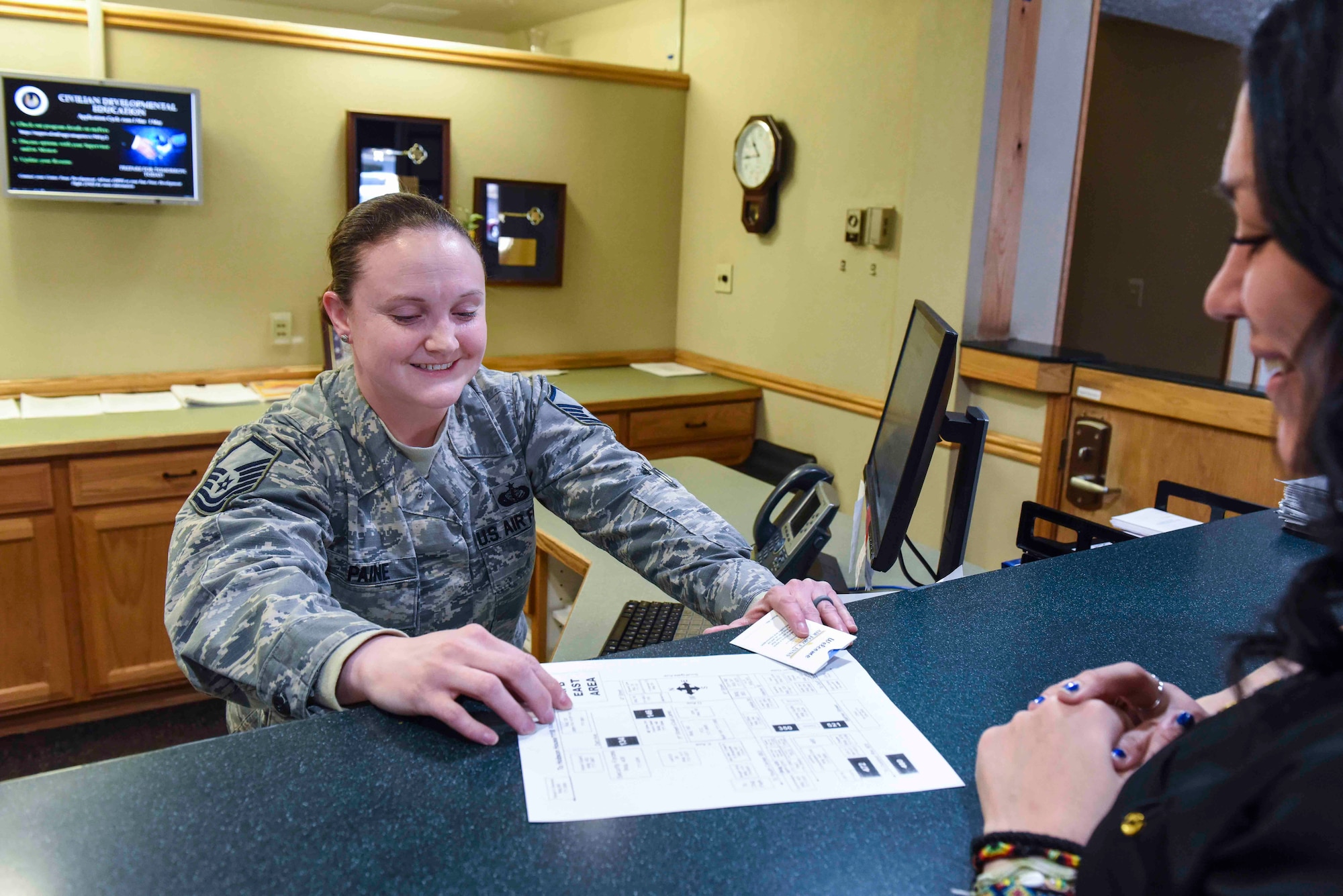 Master Sgt. Toni Paine, 419th Sustainment Services Flight chief, gives directions to a guest March 2, 2019,