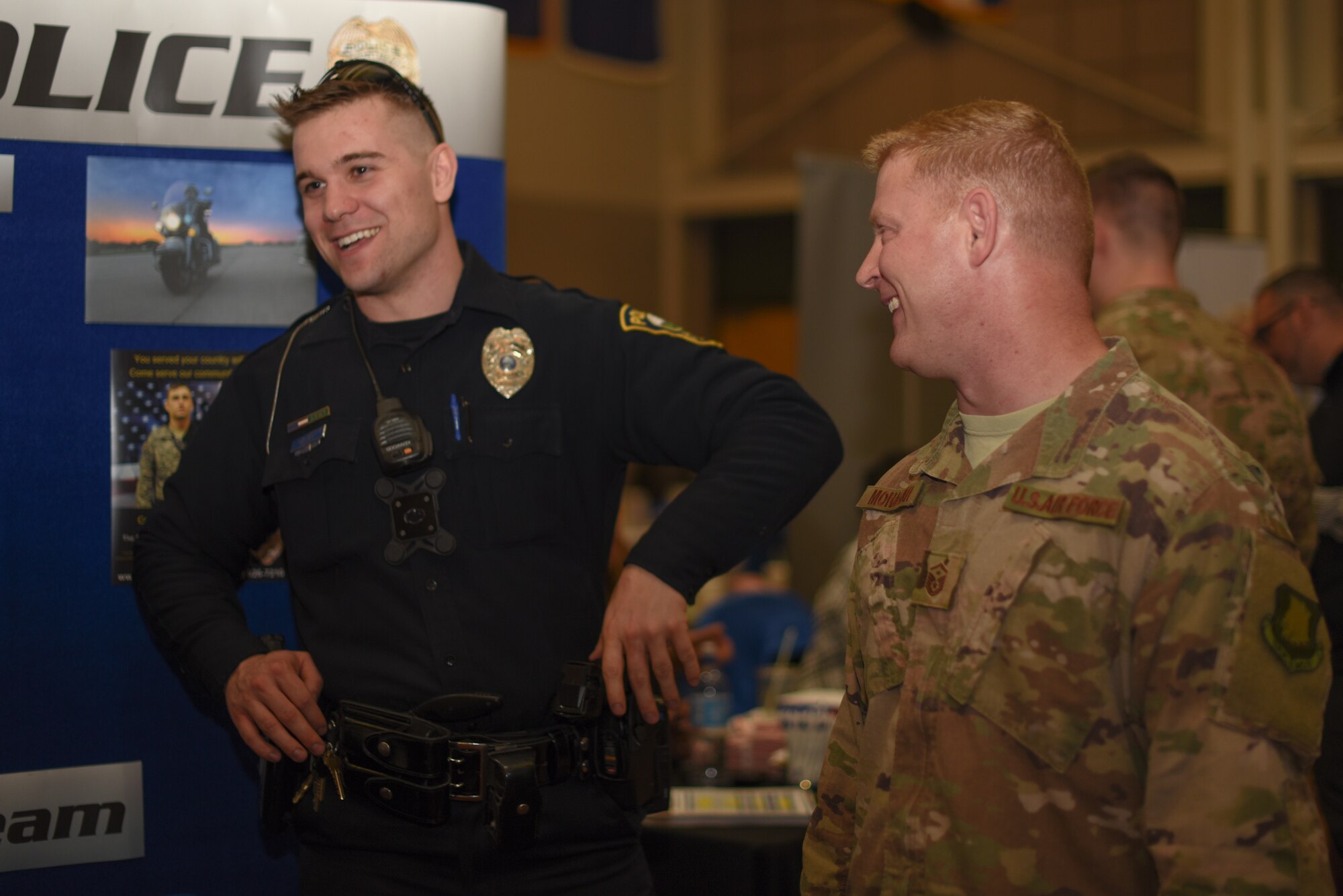 Master Sgt. Jason Monaghan, 22nd Wing Staff Agency first sergeant, discusses employment opportunities with the Salina police officers March 20, 2019 at McConnell Air Force Base, Kan. The job fair hosted 70 employers in the Dole Community Center Ballroom. (U.S. Air Force photo by Airman 1st Class Alexi Myrick)