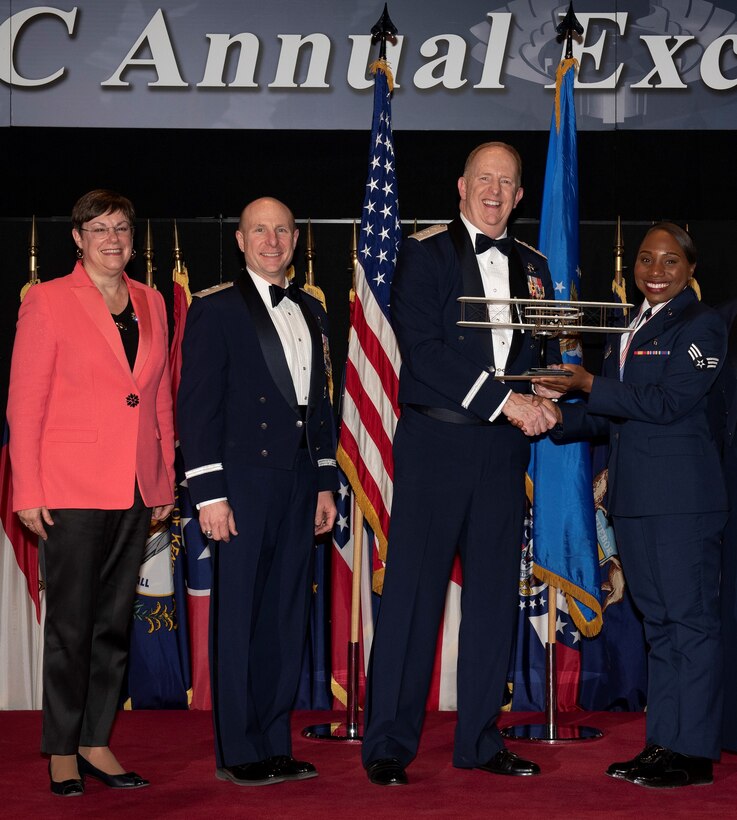 From left to right: Patricia M. Young, Air Force Materiel Command executive director; Maj. Gen. Carl Schaefer, AFMC deputy commander; Lt. Gen. Robert McMurry, AFMC commander; and Senior Airman Mutia Graham, Air Force Test Center; pose for a photo during AFMC's Annual Excellence Awards Banquet March 6, 2019, at Wright-Patterson Air Force Base, Ohio. McMurry presented Graham with a trophy for being selected as the command's Airman of 2018. (U.S. Air Force photo by Michelle Gigante)