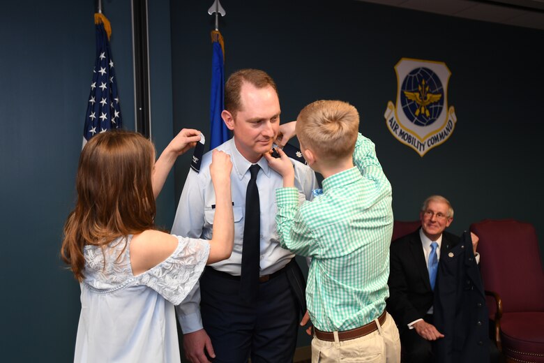 U.S. Air Force Col. Christopher Holland pins on the rank of colonel.