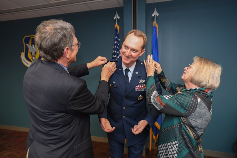 U.S. Air Force Col. Christopher Holland pins on the rank of colonel.