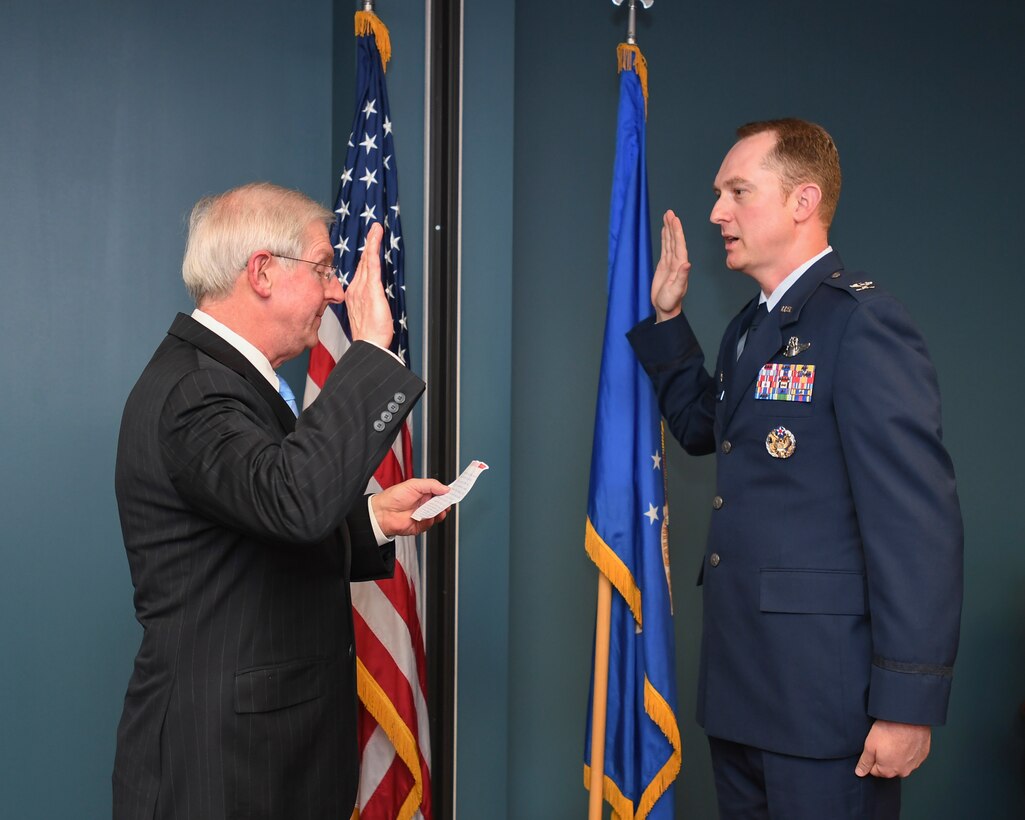 U.S. Air Force Col. Christopher Holland pins on the rank of colonel.