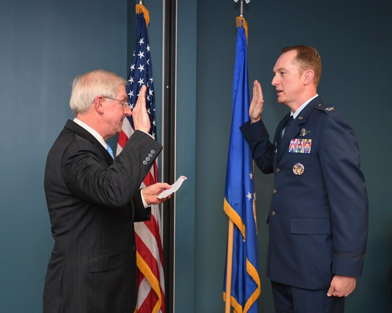 U.S. Air Force Col. Christopher Holland pins on the rank of colonel.