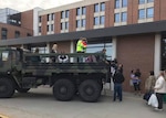 Stranded hospital staff and family members are loaded into a former military truck to be transported home, away from flood waters in Fremont, Nebraska.  After the emergency is over the truck will be converted for use in firefighting and then issued to a volunteer fire department.