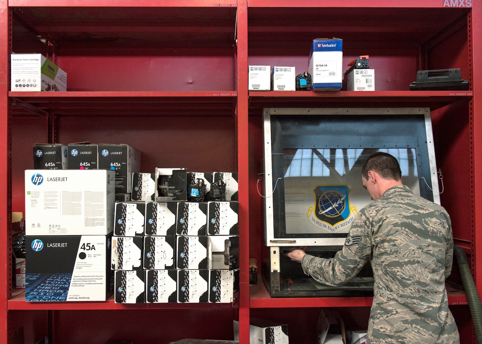 U.S. Air Force Staff Sgt. Tyler Ferris,  92nd Maintenance Group Air Force Repair Enhancement Program technician, prepares to refill an ink cartridge at Fairchild Air Force Base, Washington, March 20, 2019. The AFREP team has contributed toward the “Green in 19” initiative by implementing environmentally friendly practices through recharging ink cartridges to mitigate the many adverse effects of just throwing them away. (U.S. Air Force photo by Airman 1st Class Whitney Laine)