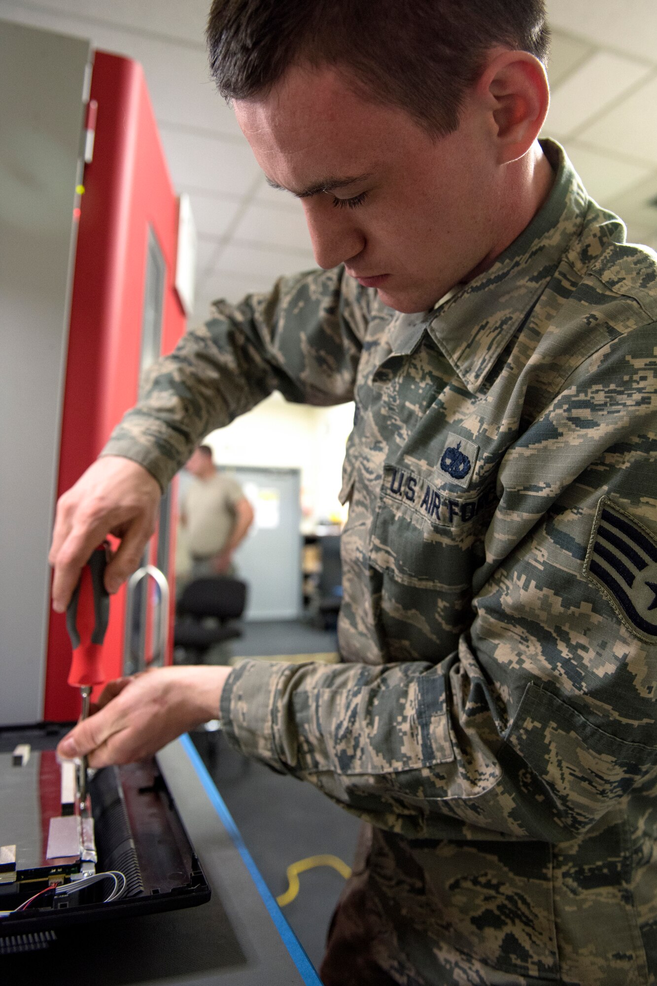 U.S. Air Force Staff Sgt. Tyler Ferris, 92nd Maintenance Group Air Force Repair Enhancement Program technician, repairs a computer monitor at Fairchild Air Force Base, Washington, March 20, 2019. AFREP has collected desktop monitors from across the base to repair and distribute back into workstations. Each one cuts costs, time and doesn’t add to a growing pile of electronics waste that is a growing ecological issue in an ever more technological world. (U.S. Air Force photo by Airman 1st Class Whitney Laine)