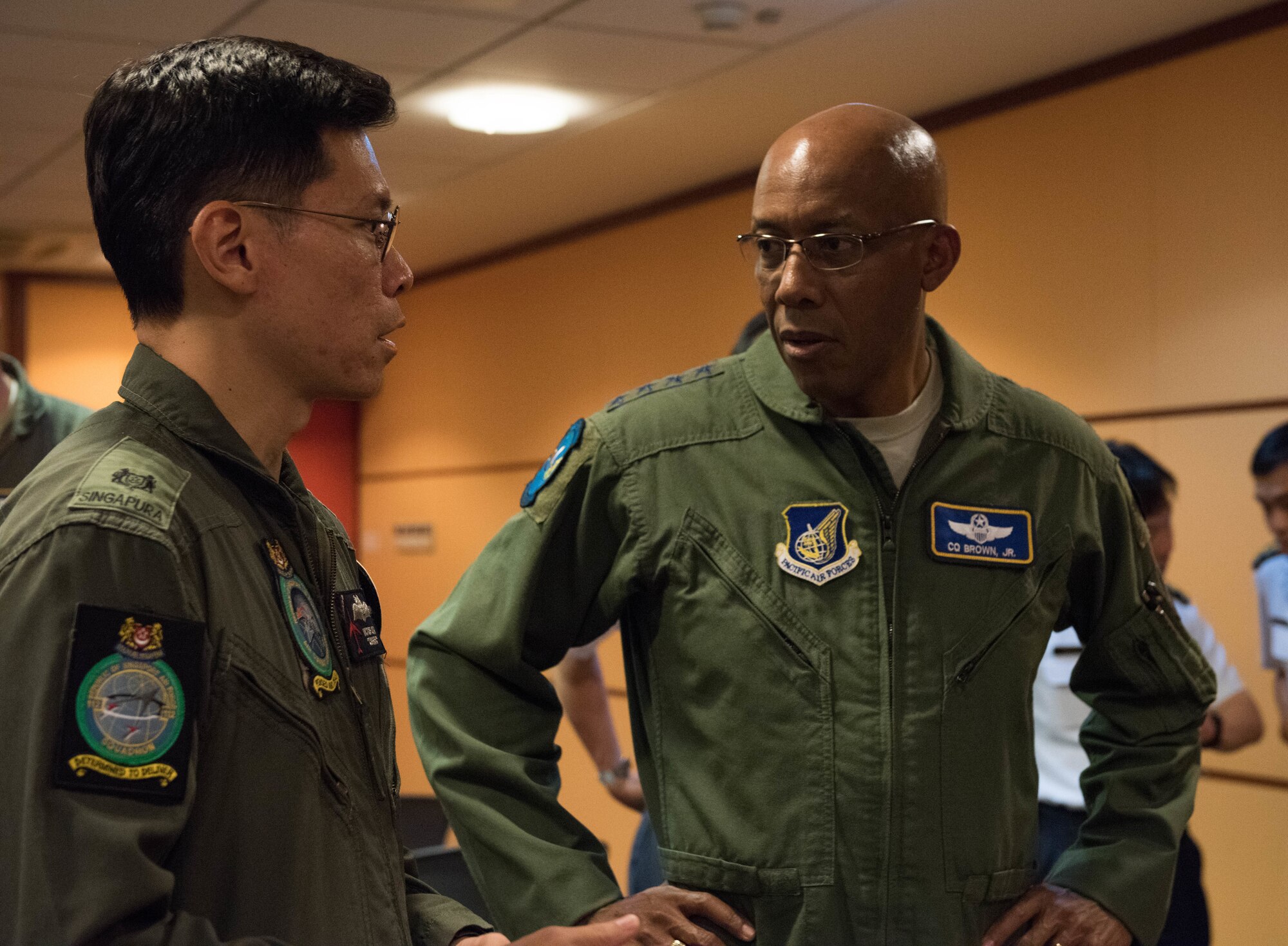 U.S. Air Force Gen. CQ Brown, Jr., Pacific Air Forces commander, talks with a member of the Singapore Air Force during a visit to Changi Air Base, Singapore, March 19, 2019.