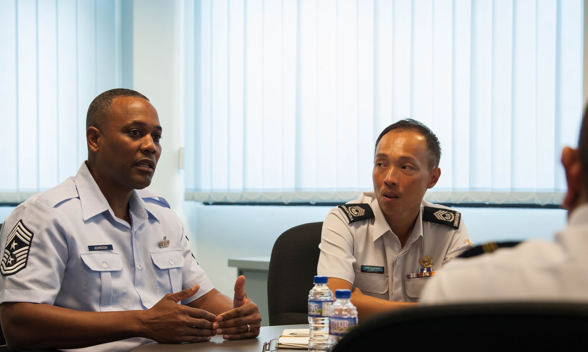 U.S. Air Force Chief Master Sgt. Anthony Johnson, Pacific Air Forces (PACAF) command chief, has a discussion with Republic of Singapore Air Force senior military experts and warrant officers during a visit to Sembawang Air Base, Singapore, March 19, 2019.