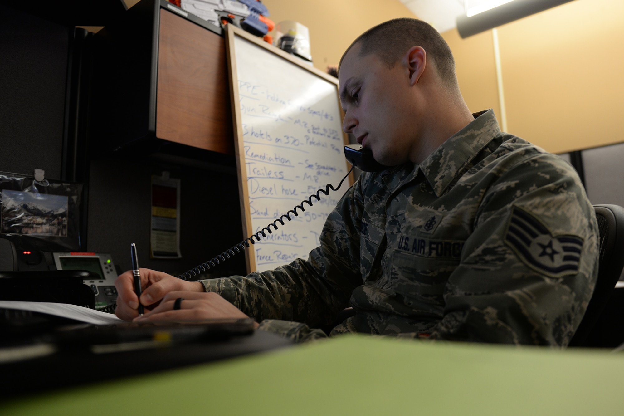 Staff Sgt. Jason Rice, 55th Contracting Squadron commodities flight NCO in charge, talks on the phone March 19, 2019, on Offutt Air Force Base, Neb. Rice was part of the team that completed 22 contract actions totaling $650,000 during recent flood preparations. (U.S. Air Force photo by Tech. Sgt. Rachelle Blake)
