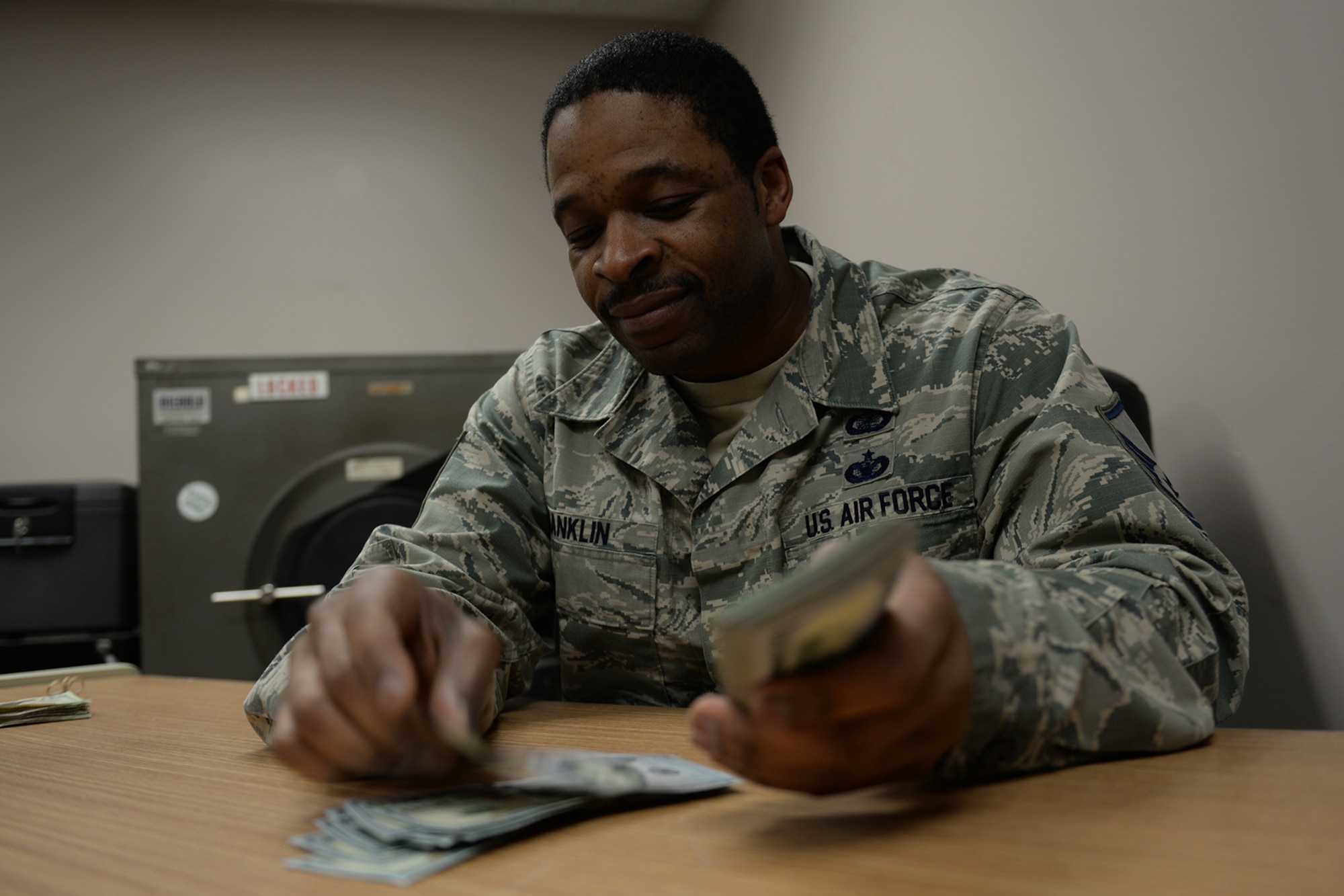 Master Sgt. Brandon Franklin, 55th Comptroller Squadron, counts money March 19, 2019, on Offutt Air Force Base, Neb. Rice was a paying agent during recent flood preparation purchases in the community. (U.S. Air Force photo by Tech. Sgt. Rachelle Blake)