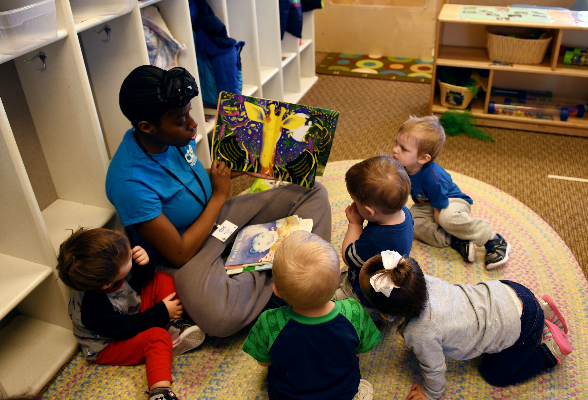 Jumanae Evans, a 28th Force Support Squadron child and youth program assistant, reads to the children in room 137 at the McRaven Child Development Center on Ellsworth air Force Base, S.D., March 19, 2019. Air Force CDC’s are currently operating under the Creative Curriculum preschool program and will soon shift to the Early Learning Matters curriculum.