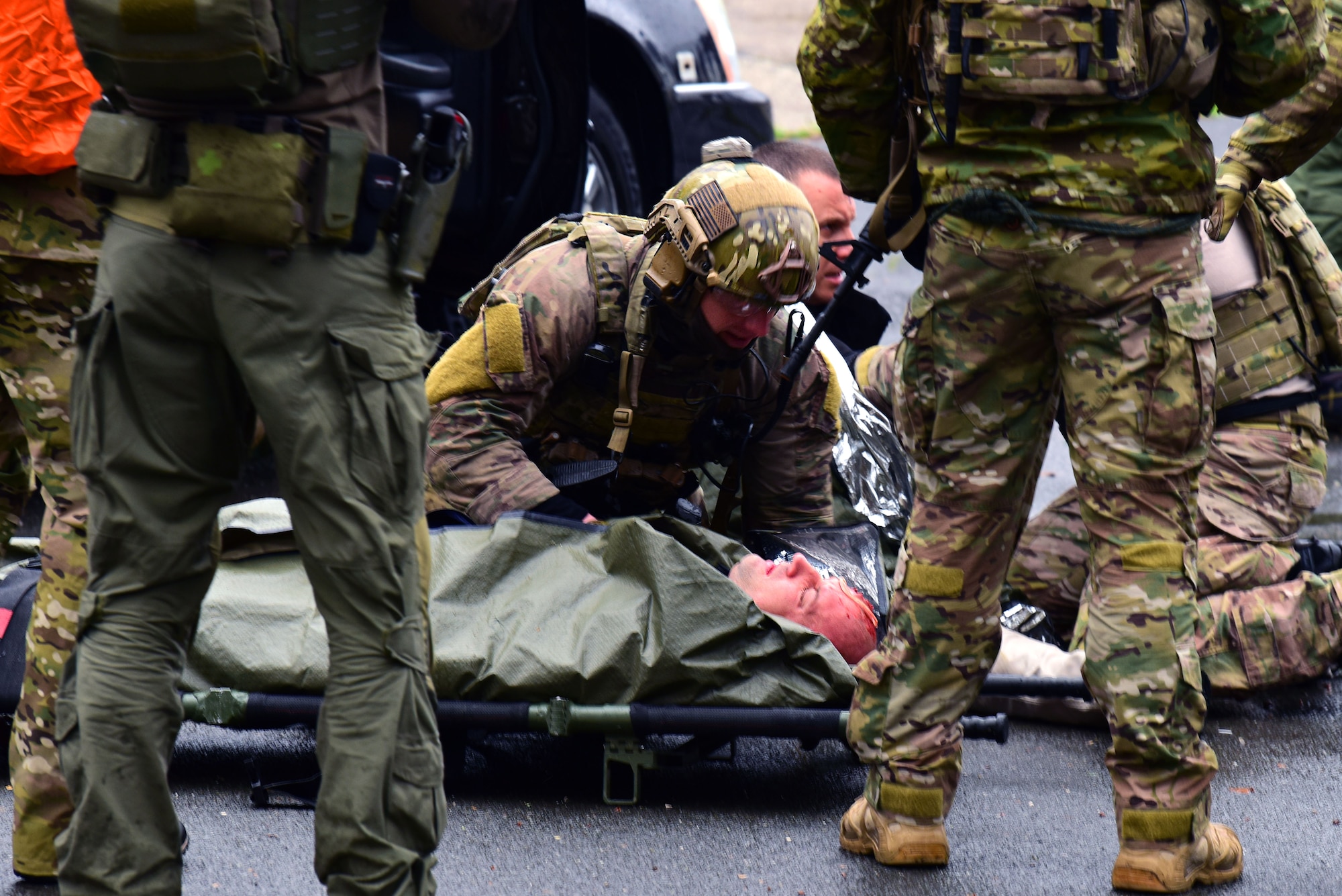 A 57th Rescue Squadron Guardian Angel pararescueman, stationed at Aviano Air Base, Italy, stabilizes a simulated causality during a Non-combatant Evacuation Operation exercise at the Police Academy, Croatia, March 18, 2019. The 31st Fighter Wing and the 352nd Special Operations Wing, RAF Mildenhall, England, partnered with the government of Croatia and the U.S. Embassy Zagreb to test their abilities to plan and execute emergency response during a crisis.  (U.S. Air Force photo by Senior Airman Kevin Sommer Giron)