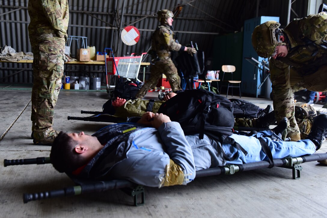 57th Rescue Squadron Guardian Angel pararescuemen, stationed at Aviano Air Base, Italy, perform medical evacuation procedures on simulated casualties during a Non-combatant Evacuation Operation exercise near Zagreb, Croatia, March 18, 2019. Pararescuemen provided personnel recovery and casualty evacuation expertise to the exercise. (U.S. Air Force photo by Senior Airman Kevin Sommer Giron)