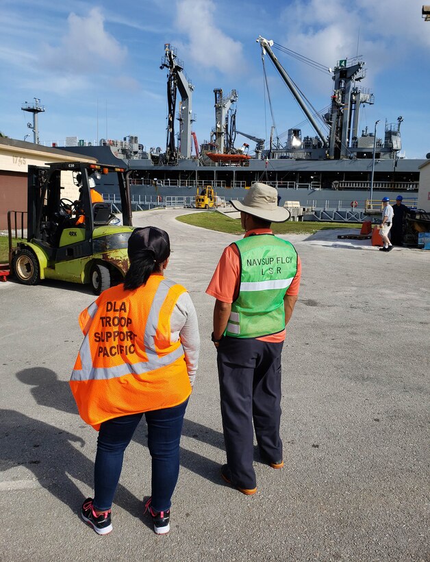 DLA Troop Support Indo-Pacific forward logistics specialist Bobbie Delgado, wearing an orange vest, observes loading operations for $221,000 of subsistence items for two Navy vessels prior to embarking for Pacific Partnership 2019, March 4, 2019 in Guam.