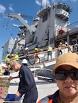 DLA Troop Support Indo-Pacific forward logistics specialist Bobbie Delgado, standing in the right foreground, observes the loading of more than $410,000 in subsistence supplies March 14, 2019 in Guam.
