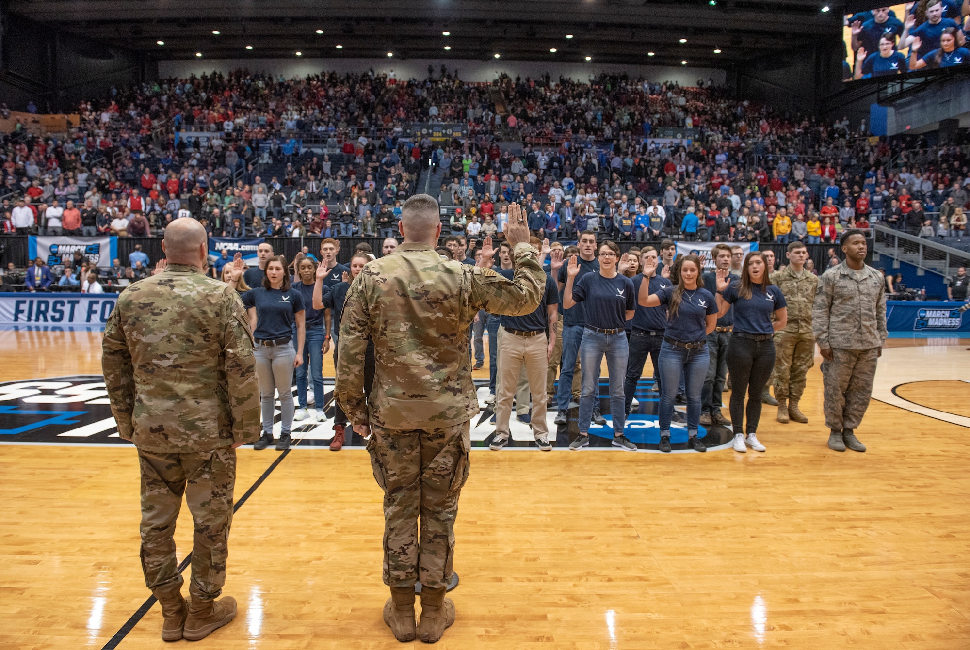 Col. Thomas P. Sherman, 88th Air Base Wing and installation commander, swears individuals from around the Miami Valley area into the Air Force Delayed Enlistment Program during half-time events of a game between Fairleigh Dickinson Knights and Prairie View A&M Panthers as part of the NCAA First Four Tournament at the University of Dayton Arena in Dayton, Ohio, March 19, 2019. (U.S. Air Force photo by Michelle Gigante)