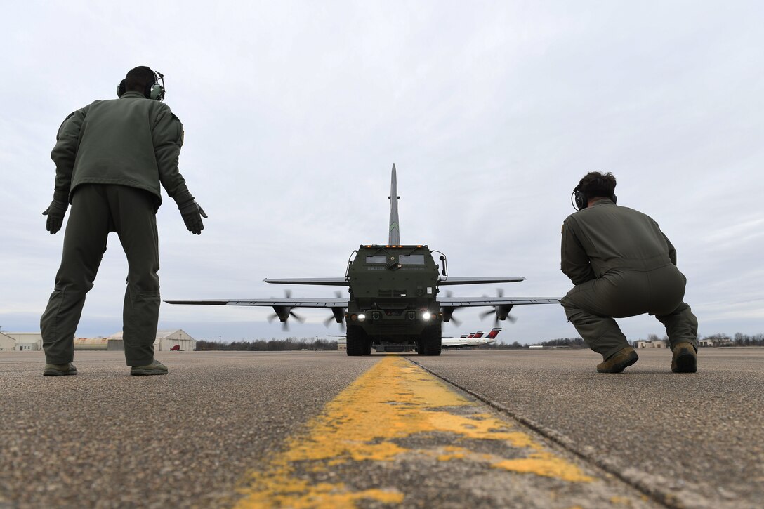 Airmen  load a M142 High Mobility Artillery Rocket System onto a C-130J
