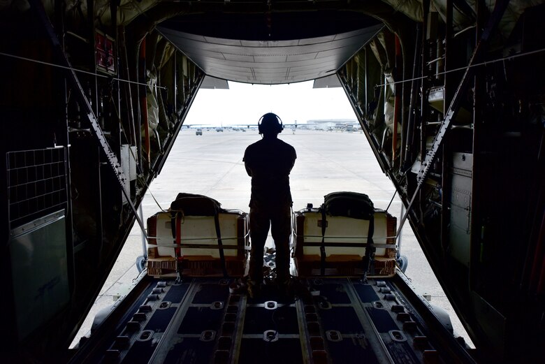 An airman looks out the back of a C-130J Super Hercules during the fly-in exercise