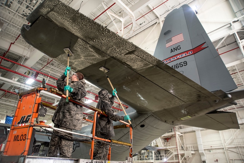 Airmen wash a C-130H Hercules