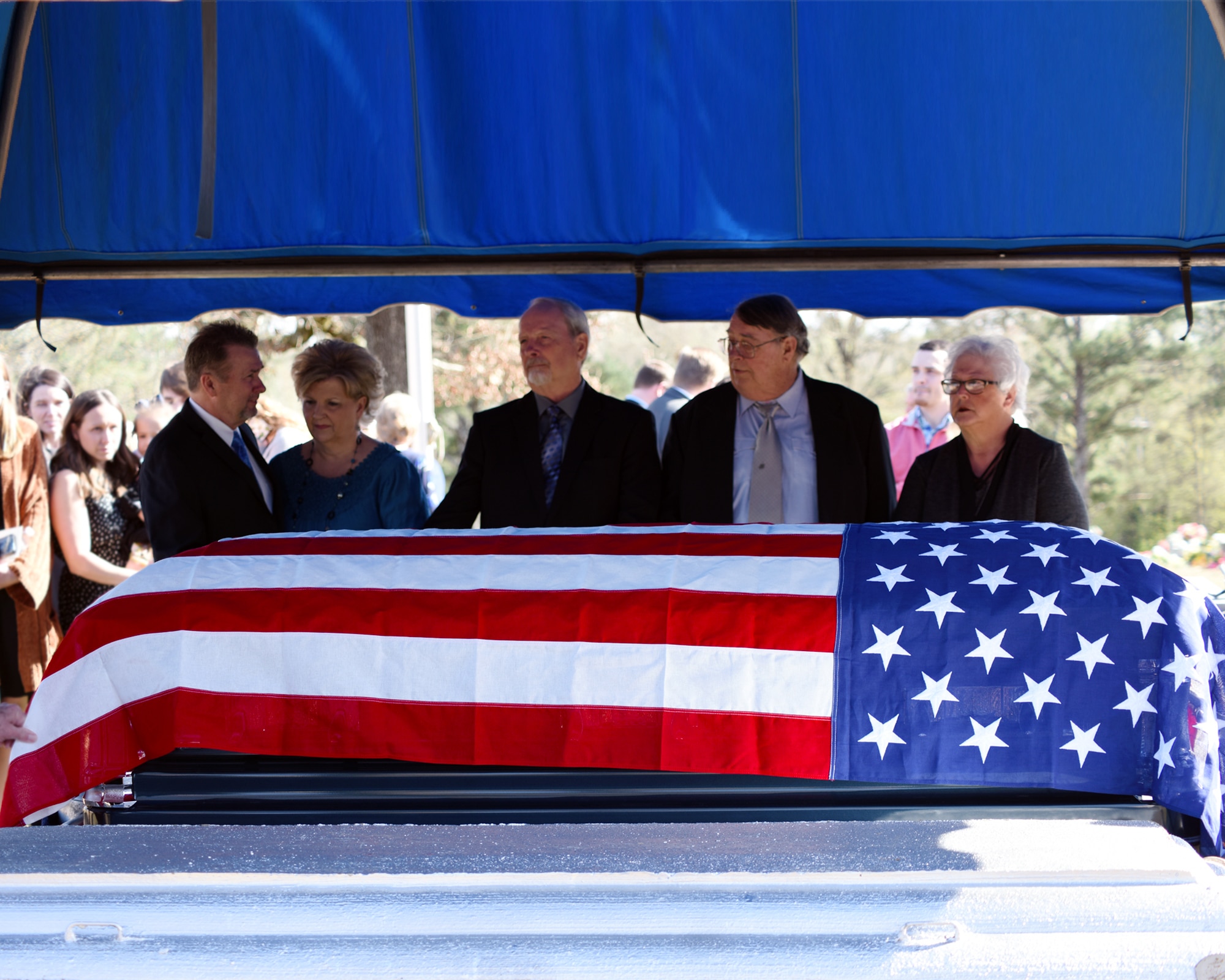 The sons and daughters of John Cockerham, a local World War II veteran, stand by his casket March 16, 2019, at Center Hill Baptist Church Cemetery in Hamilton, Mississippi. At the funeral, members from the Columbus Air Force Base Honor Guard performed a rifle salute, played taps, folded and presented an American flag to his wife, Georgia Mae. (U.S. Air Force photo by Sharon Ybarra)