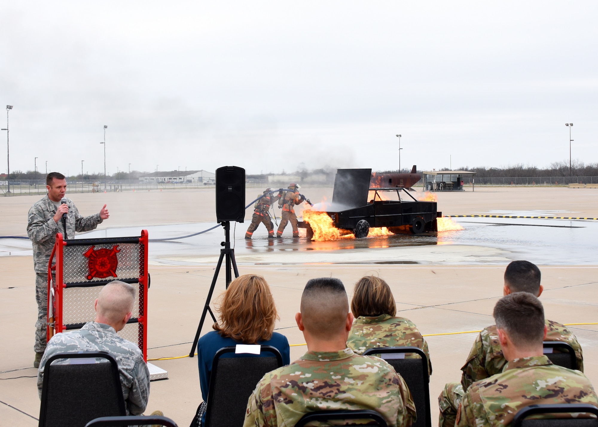 U.S. Air Force Tech. Sgt. Jayton Washington, 312th Training Squadron instructor, discusses the advantages of the new mobile fire pumps during a demonstration at the Louis F. Garland Department of Defense Fire Academy on Goodfellow Air Force Base, Texas, March 20, 2019. The pumps are easier to transport to difficult locations and each pump allows two fire engines to be returned to storage. (U.S. Air Force photo by Airman 1st Class Zachary Chapman/Released)