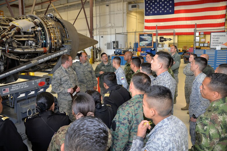 Staff Sgt. Luis Velez, 837th Training Squadron international logistics training flight instructor (third from left), translates English to Spanish while Senior Airman Alexander Alvillar and Master Sgt. Sean Preston, propulsion mechanics, describe features of a C-5M Super Galaxy engine to Inter-American Air Forces Academy students and instructors March 18, 2019 at Joint Base San Antonio-Lackland, Texas.