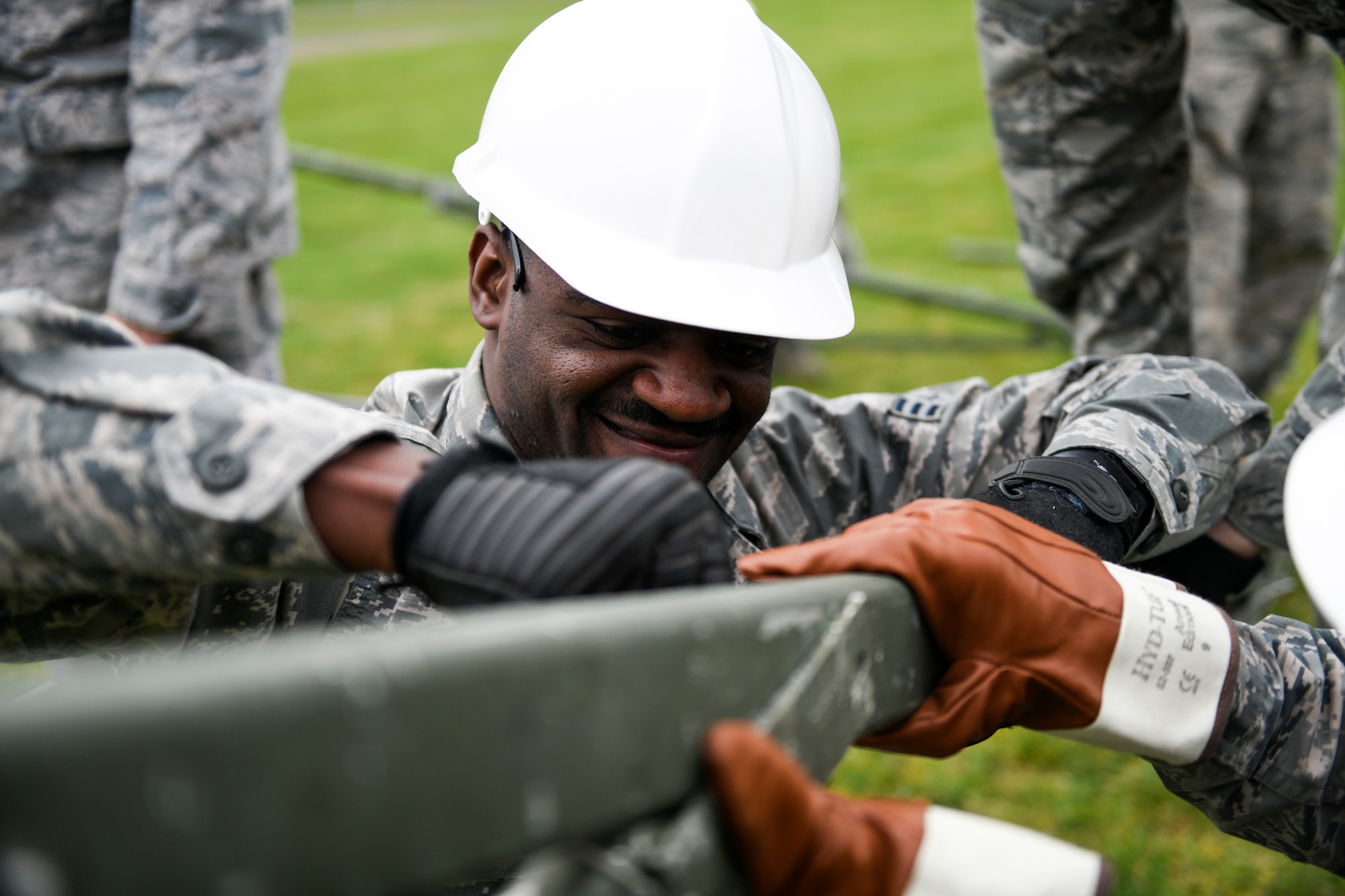 Senior Airman Lamarr Tims, 48th Civil Engineer Squadron heating, ventilation, and air conditioning technician, secures a Tent Extendable Modular Personnel tent frame with a safety pin during an inventory check and training day at Royal Air Force Feltwell, England, March 22, 2019. A TEMPER tent has an aluminum frame and is primarily covered with a vinyl coated polyester duck cloth that is fire, mildew and water resistant. (U.S. Air Force photo by Senior Airman Malcolm Mayfield)