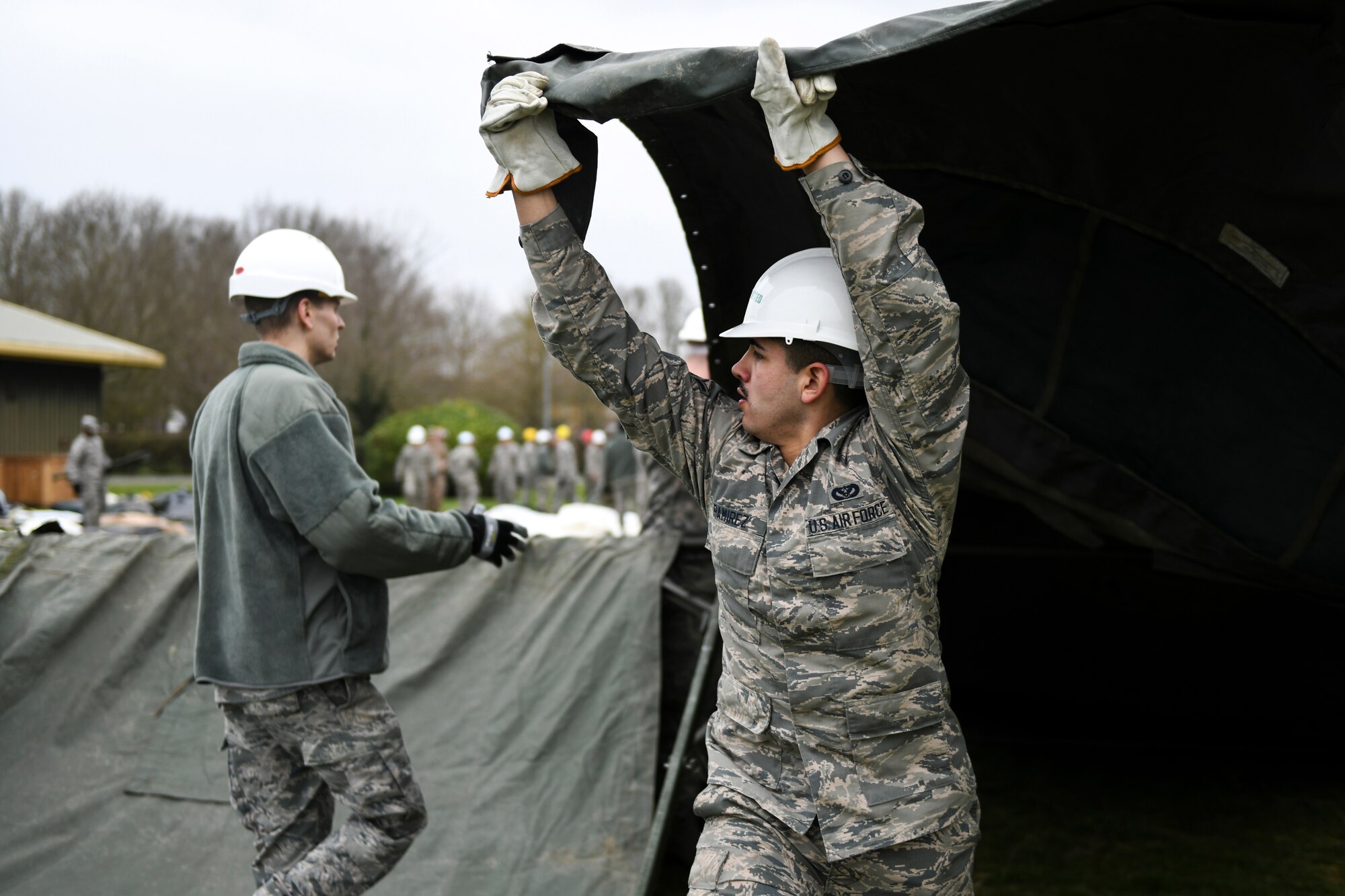 Airman George Ramirez, 48th Civil Engineering Squadron heating, ventilation, and air conditioning technician, puts the main cover fabric over a Tent Extendable Modular Personnel tent frame during an inventory check and training day at Royal Air Force Feltwell, England, March 22, 2019. A TEMPER tent is a highly versatile design suitable for a wide range of environments and can be assembled from a standard module to a multitude of configurations.  (U.S. Air Force photo by Senior Airman Malcolm Mayfield)