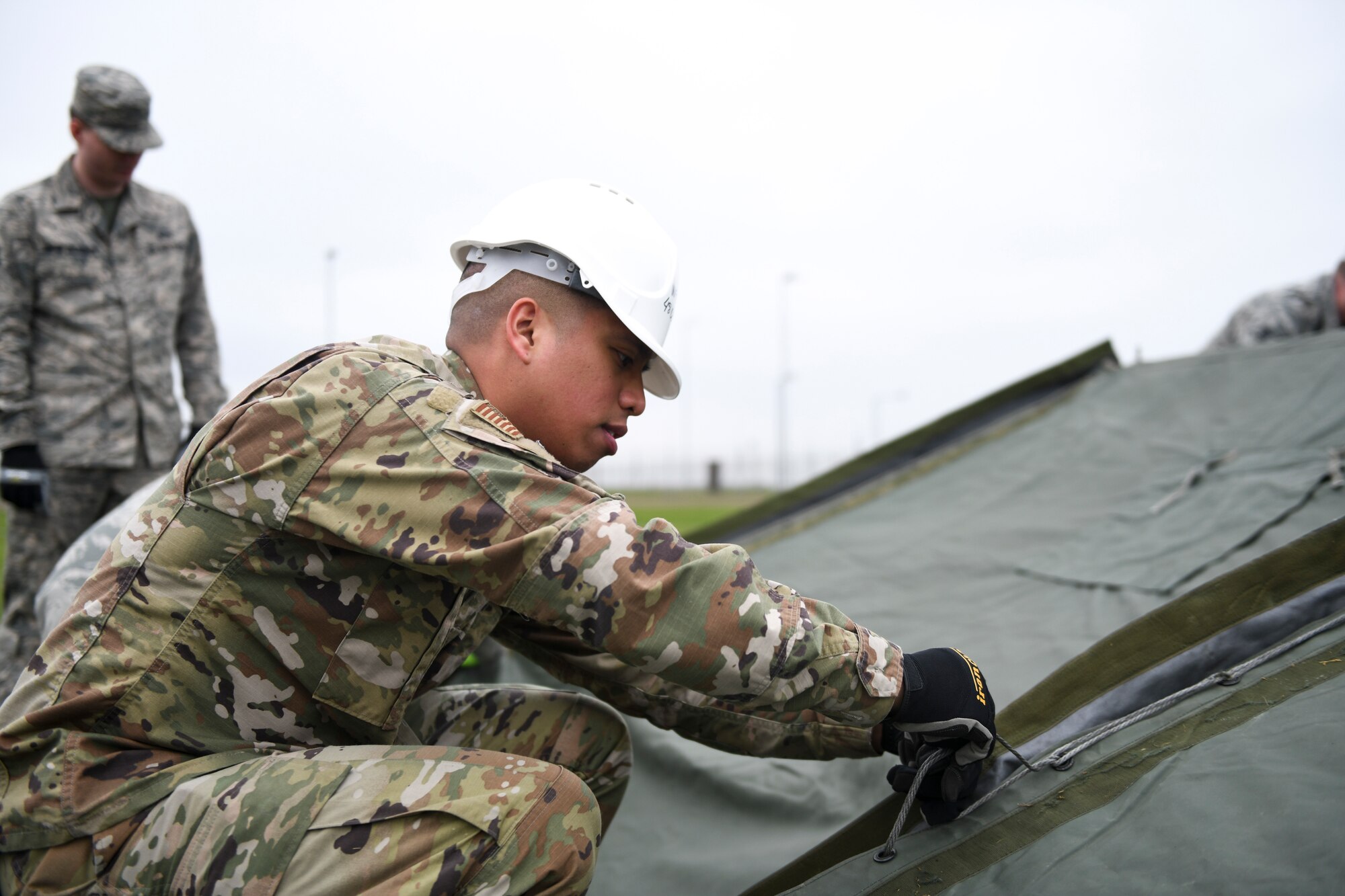 A 48th Civil Engineer Squadron member secures the main cover fabric of a Tent Extendable Modular Personnel tent during an inventory check and training day at Royal Air Force Feltwell, England, March 22, 2019. This training emphasizes readiness - one of the 48th Fighter Wing’s priorities. (U.S. Air Force photo by Senior Airman Malcolm Mayfield)