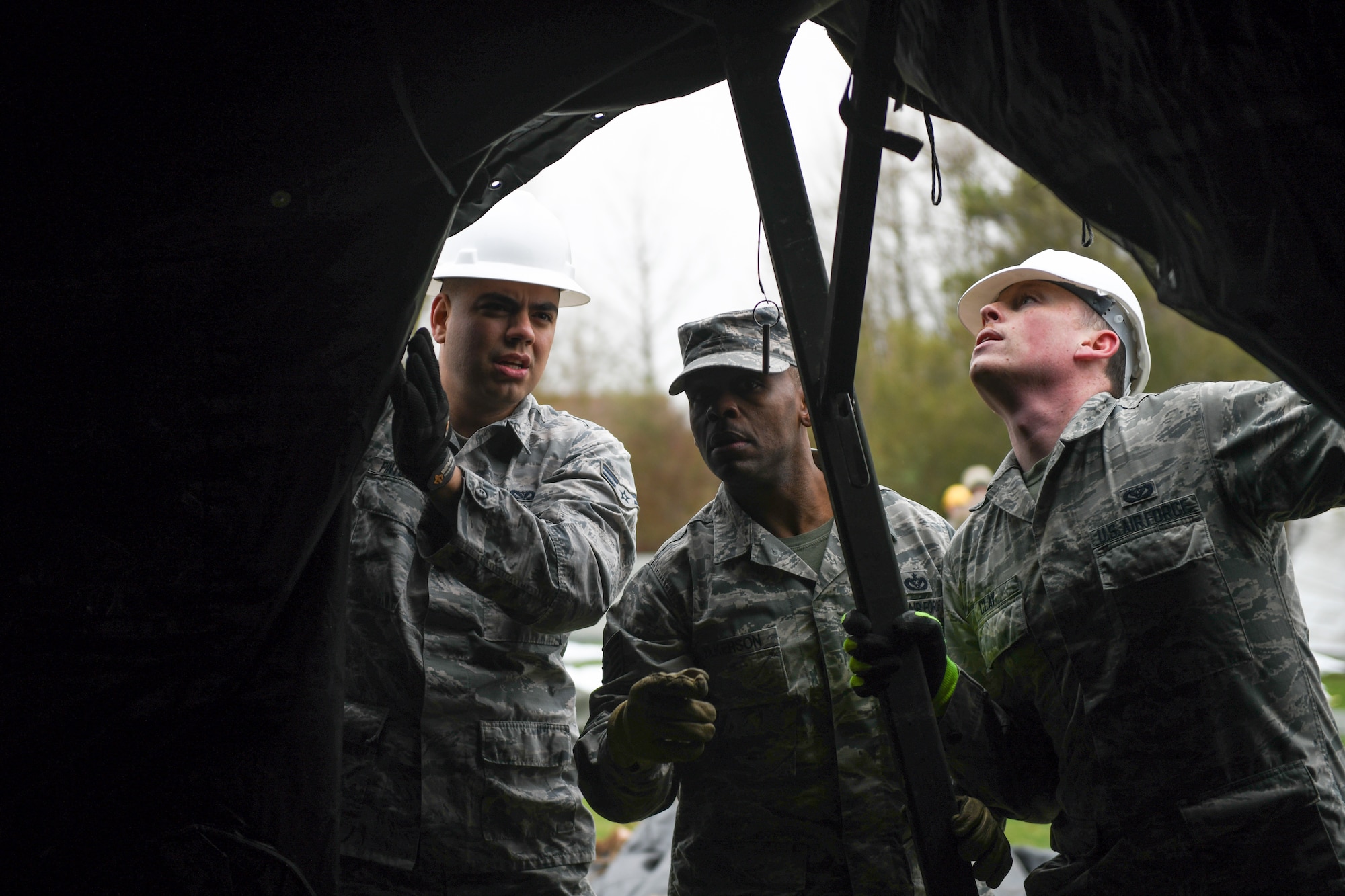 48th Civil Engineer Squadron members examine newly assembled Tent Extendable Modular Personnel tent during an inventory check and training day at Royal Air Force Feltwell, England, March 22, 2019. These types of trainings support the 48th Fighter Wing mission of generating combat-ready Airmen. (U.S. Air Force photo by Senior Airman Malcolm Mayfield)