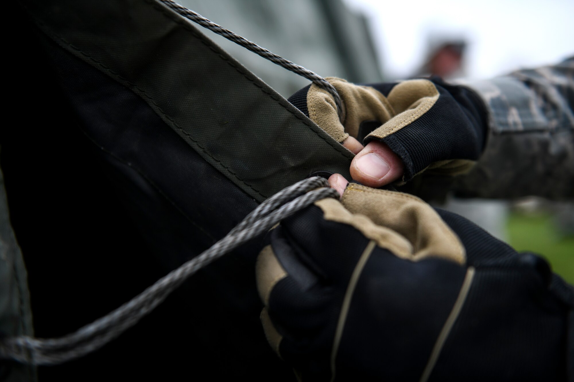 A 48th Civil Engineer Squadron member laces together the main cover fabric of a Tent Extendable Modular Personnel tent frame during an inventory check and training day at Royal Air Force Feltwell, England, March 22, 2019. This training was in preparation for a squadron-level exercise, which will test 48th CES Airmen on various deployment-related tasks and undergo a bare base beddown. (U.S. Air Force photo by Senior Airman Malcolm Mayfield)